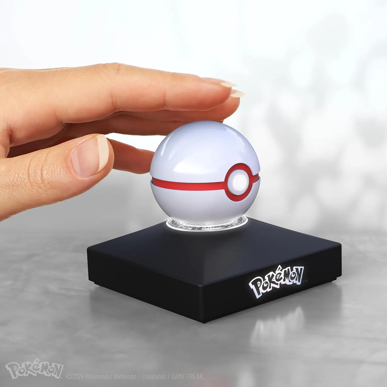 The Wand Company Pokémon Trainer Mini Poké Ball Range of Authentic Replicas - Realistic, Electronic, Die-Cast Poké Ball with Display Stand Light Features (Mini Premier Ball)